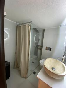 a bathroom with a shower and a sink and a toilet at Amara Luxury in Kavála +34 photos