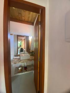 a bathroom with a sink and a mirror at Casa Tiririca vista mar in Itacaré