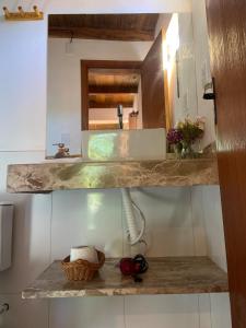 a bathroom counter with a sink and a mirror at Casa Tiririca vista mar in Itacaré +34 photos