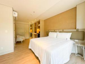 a bedroom with a large white bed in a room at Hotel Blue Sea in Itapema