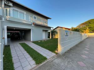 a building with a garage with a car parked in it at Residencial Beira Mar in Florianópolis
