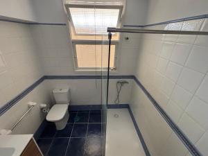 a bathroom with a toilet and a glass shower at isacar la real in Santa Cruz de la Palma