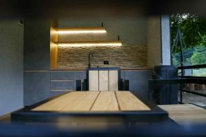 a wooden table in a room with a light at Netara in Khizabavra