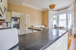 a kitchen with a large counter top in a room at Apartment 1, 2 Victoria Street, Armagh in Armagh +6 photos