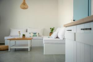 a living room with a white couch and a table at Anthea Suites in Engares
