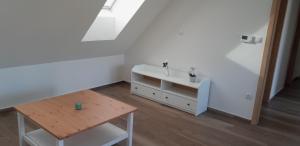 a white room with a table and a sink at Apartmán u Štěpána 