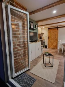 a living room with a brick wall and a table at House Notturno in Otočac