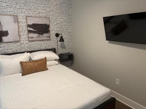 a bedroom with a bed and a flat screen tv at 1280 Bungalow in Atlanta