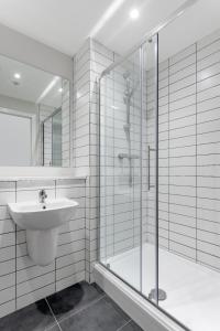 a white bathroom with a sink and a shower at Gorgeous GF 2 Bed 2 bathroom Apartment Liverpool 3 in Liverpool