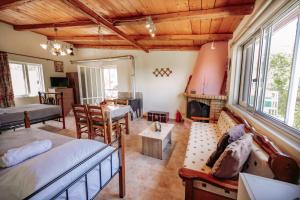 a living room with a bed and a fireplace at Nicola's House in Tsivarás