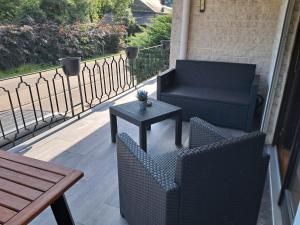 a patio with two chairs and a table and a bench at Balcons de la semois in Vresse-sur-Semois