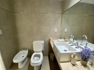 a bathroom with a toilet and a sink at Palermo Soho Luxury Flat with pool and Amenities in Buenos Aires +5 photos