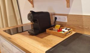 a coffee maker sitting on a counter in a kitchen at La Cadurcienne "Love room" jacuzzi & pièce secrète Cahors centre historique in Cahors