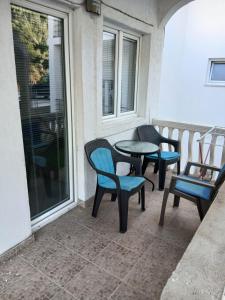 a patio with two chairs and a table on a balcony at Apartmani Pikula in Sutomore