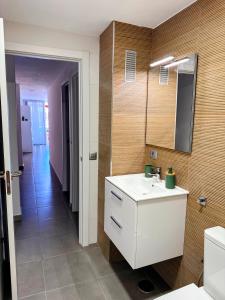 a bathroom with a white sink and a mirror at Los Molinos in Puerto Naos +12 photos