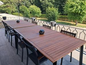 a wooden table and chairs on a patio at Balcons de la semois in Vresse-sur-Semois