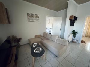 a living room with a couch and a table at Castle View Apartment in Mytilene