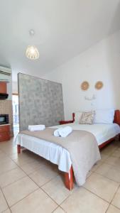 a bedroom with two beds with a face on the wall at Villa Christina Sea Side B in Hanioti