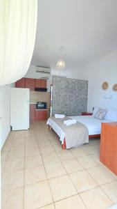 a bedroom with two beds and a refrigerator in it at Villa Christina Sea Side B in Hanioti