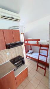a kitchen with a stove and a bunk bed at Villa Christina Sea Side B in Hanioti +99 photos