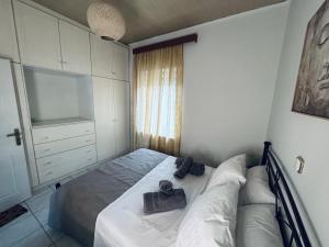 a small bedroom with a bed and a television at Castle View Apartment in Mytilene