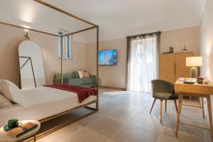 a bedroom with a bed and a desk and a chair at Elysium Boutique Apartment - Modica in Modica