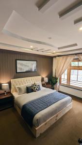 a bedroom with a large bed in a room at Soma Hotels Skardu in Skardu