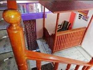 a wooden stair case with a table in a room at Hotel TAUHURA in Srinagar