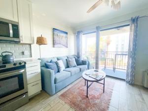 a living room with a couch and a table at Coastal King at Seaside Villas Ocean View in Hilton Head Island