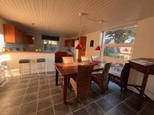 a kitchen and dining room with a table and chairs at Købmandsgaarden in Nakskov