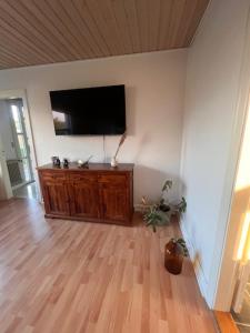 a living room with a flat screen tv on a wall at Købmandsgaarden in Nakskov