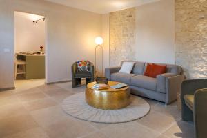 a living room with a couch and a coffee table at Elysium Boutique Apartment - Modica in Modica