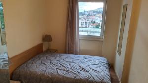 a bedroom with a bed and a large window at Funchal Apartament Marina View with PARKING FREE in Funchal