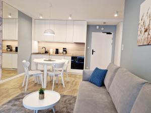 a living room with a couch and a table at Morskie Sny in Grzybowo