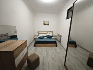a bedroom with two beds and a dresser in it at Komitas premium apartment in Yerevan