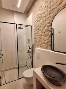 a bathroom with a sink and a glass shower at The Ranch in Kfar Hazîr +50 photos