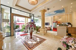 a lobby with a vase of flowers on the floor at Victory Hotel in Ho Chi Minh City