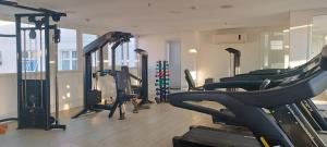 a gym with a bunch of treadmills and machines at Hotel Atlântico Tower in Rio de Janeiro
