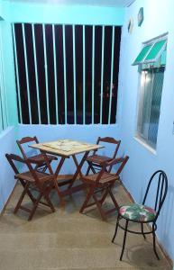 a wooden table and two chairs and a window at Hospedagem up home Natureza e Simplicidade in Barra de Guaratiba +28 photos