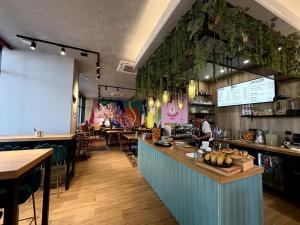 a restaurant with a counter and a bar with tables at Suite Spa privative avec jacuzzi, massage & sauna in Fontenay-aux-Roses