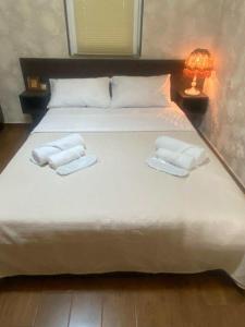 a bed with two towels and a lamp on it at House Ianeti in Ianet'i