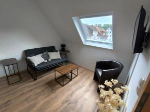 a living room with a couch and a window at Alex Meißner App 3 in Großalmerode
