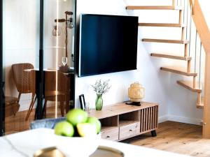 a living room with a tv on a wall at Flussblick am Töpferberg 8 in Bad Schwartau
