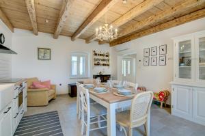 a kitchen and dining room with a table and chairs at Villa Onorina in Pomer
