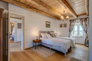 a bedroom with a large bed and a wooden ceiling at Villa Onorina in Pomer +35 photos