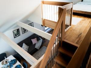 a room with a staircase with a couch at Flussblick am Töpferberg 8 in Bad Schwartau