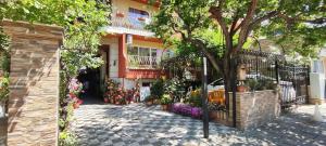 a building with a bunch of flowers in front of it at Violeta 7 Guest House in Nesebar