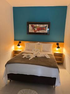 Cama ou camas em um quarto em Pousada Tropical Araçatiba