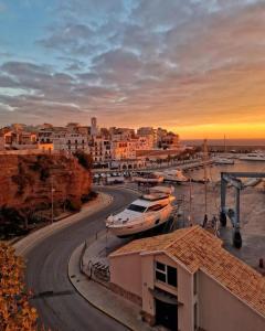 a city with boats docked in a marina at sunset at La Caseta del Port in L'Ametlla de Mar