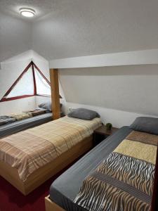 a room with two beds and a window at Motel MOSKVA in Bijelo Polje +29 photos